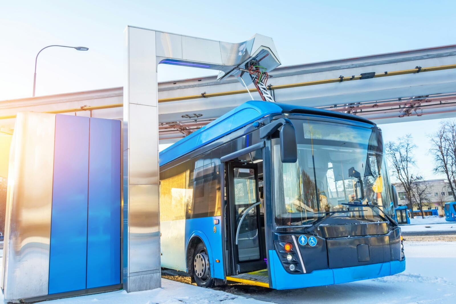 electric bus charging at docking station under a bridge